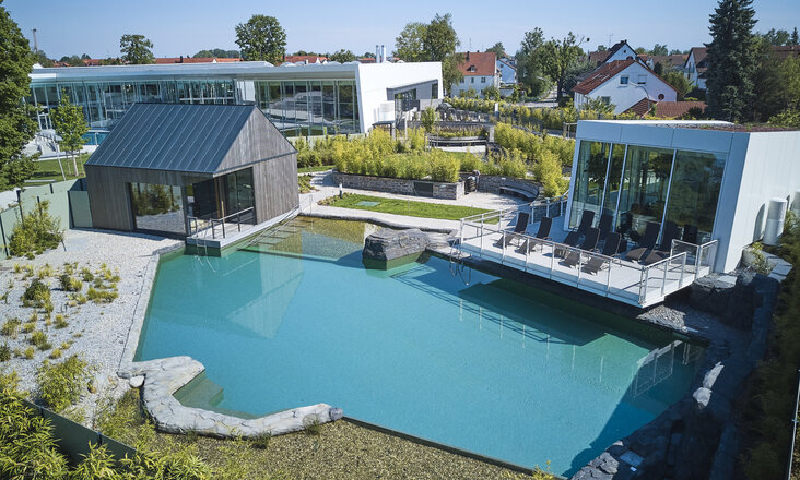 Aerial view of the water landscape with Balena system in the “fresch” leisure pool and sauna complex in Freising with pool and buildings