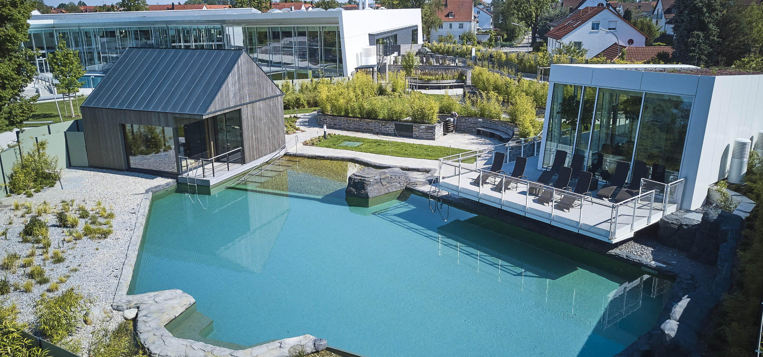 Aerial view of the water landscape with Balena system in the “fresch” leisure pool and sauna complex in Freising with pool and buildings