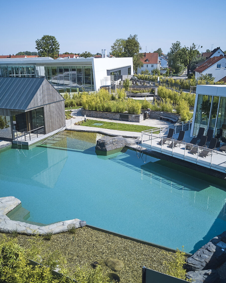 Aerial view of the water landscape with Balena system in the “fresch” leisure pool and sauna complex in Freising with pool and buildings